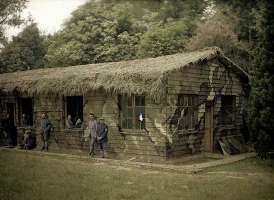 Nine French Soldiers at a Wooden Building with Military Camouflage, Soissons, Aisne, France by Fernand Cuville
